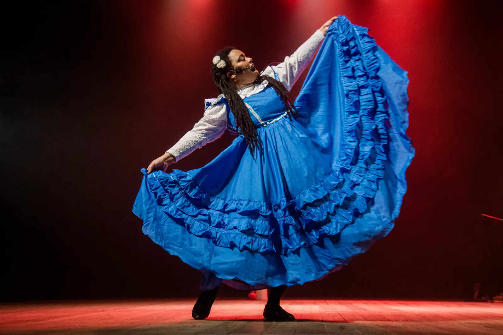 Dedy Ricardo dança em cena com um vestido azul